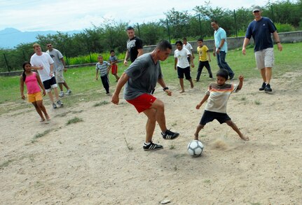 COMAYAGUA, Honduras --  Staff Sgt. Manuel Garcia, of the 612th Air Base Squadron here, faces off against one of the children from the Nuestra Señora de Guadalupe orphanage during a soccer match here Friday, July 9. The 612th ABS visits the orphanage the second Friday of each month. (U.S. Air Force photo/Tech. Sgt. Benjamin Rojek)