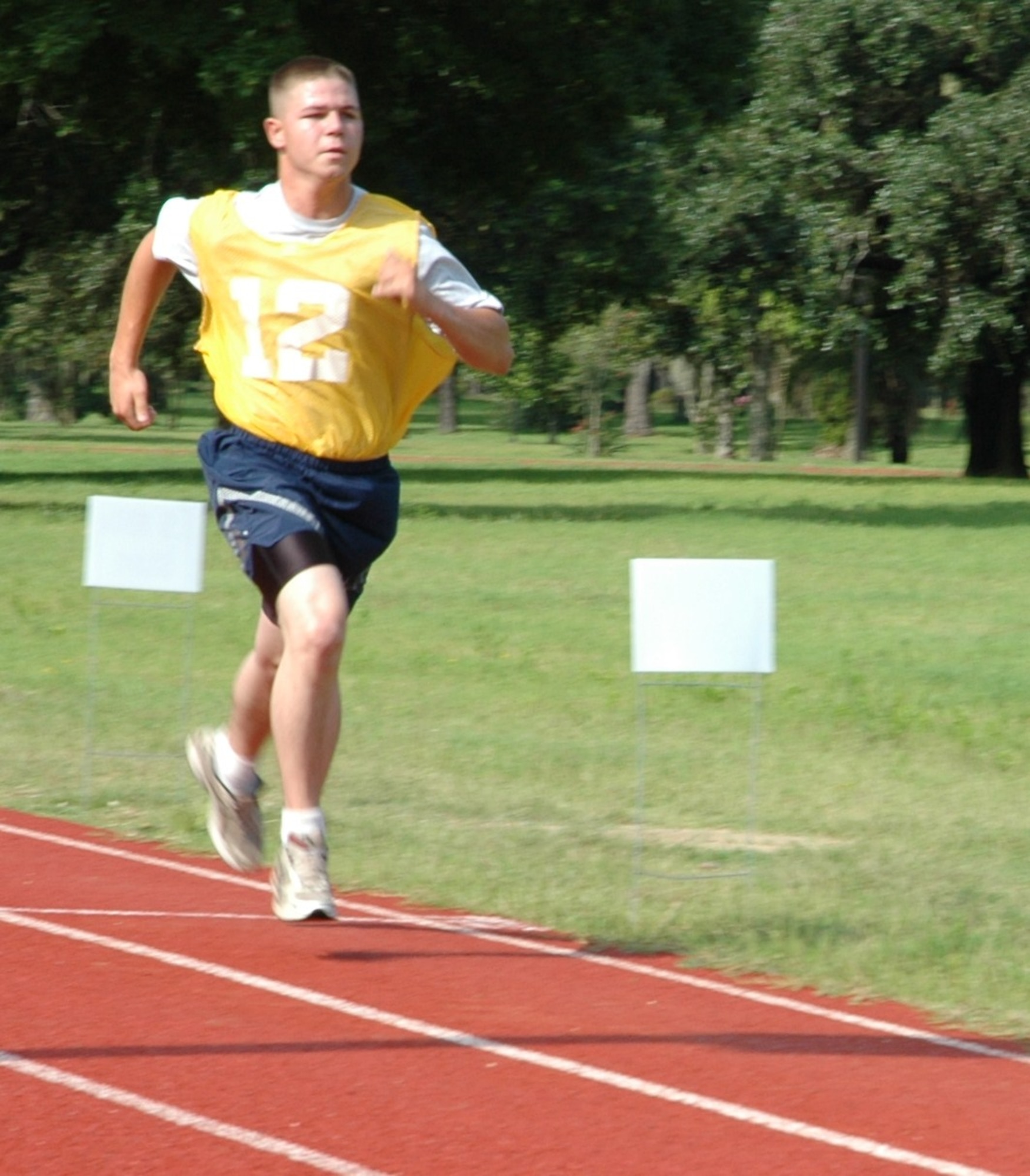 Senior Airman Kenneth M. Childers sprints to the finish line during his bi-annual physical fitness test July 11, 2010 at the base running track here. With the new standards, the run counts for 60 percent of the test, while body composition counts for 20 percent, followed by push-ups and sit-ups at 10 percent each. Under the old standards, the run counted for 50 percent, the body composition counted for 30 percent with the push-ups and sit-ups remaining the same. Senior Airman Childers is a pavements and construction equipment operator with the 560th Red Horse Squadron here. (U.S. Air Force photo/Staff Sgt. Shane Ellis)
