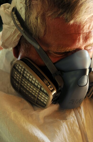 MOODY AIR FORCE BASE, Ga. -- Rick Gilbride, 23rd Civil Engineer Squadron entomology supervisor, wears a protective mask while mixing chemicals here July 9. The mask protects entomology technicians from inhaling hazardous fumes from chemicals used to combat pests around base. (U.S. Air Force photo by Airman 1st Class Joshua Green/RELEASED)