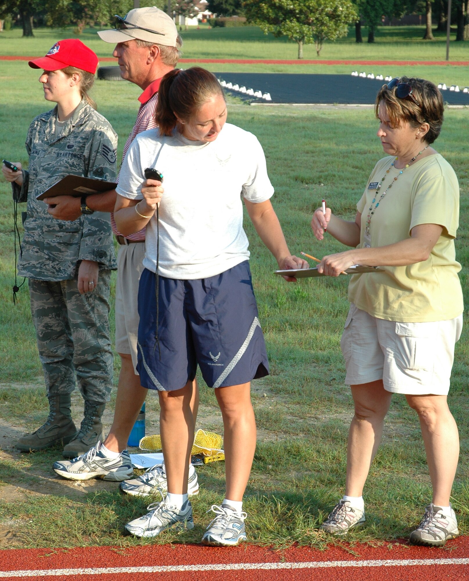 Maj. Christina R. Liegl consults with Betsy Wagner during a 315th Airlift Wing bi-annual physical assessment at 7:30 a.m. on July 11, 2010 at the base track here. Maj. Liegl works closely with the newly appointed fitness testing technicians from the 628th Force Support Squadron here. Maj. Liegl is a 315 AW flight safety officer and fitness program manager. Betsy Wagner is a 628 FSS fitness testing technician. (U.S. Air Force photo/Staff Sgt. Shane Ellis)