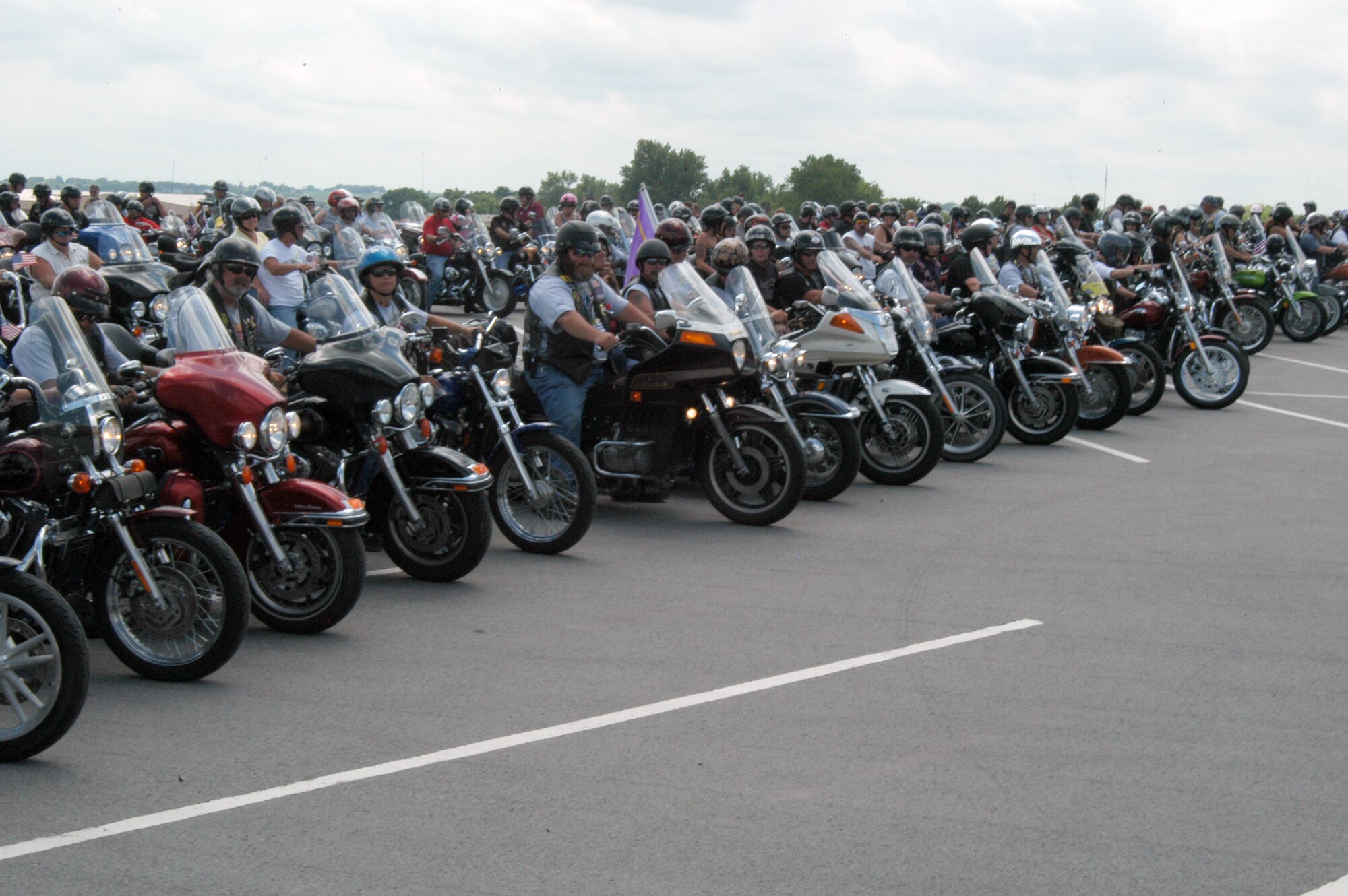 OFFUTT AIR FORCE BASE, Neb. - Motorcycle riders prepare to leave the parking lot west of the Martin Bomber Building during the 8th Annual Yellow Ribbon Run July 11. This final formation near the flightline gave riders a chance to pose for photographs before departing Offutt. U.S. Air Force photo by Airman 1st Class Peter R.O. Danielson
                                
