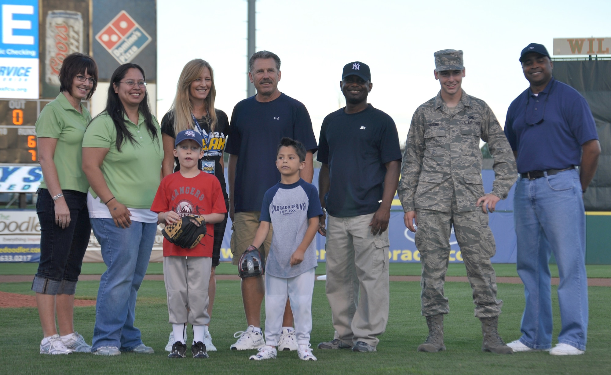 Airman 1st Class Tyler Higgins gets a group photo with other first pitch selectees July 10 at Security Service Field in Colorado Springs, Colo. Airman Higgins, a C-130 avionics technician apprentice with the 52nd Airlift Squadron, was given the opportunity to throw out a first pitch at the Colorado Springs Sky Sox game because of his recent arrival to the squadron. The 52nd AS, an Active Duty C-130 organization, is associated with the Air Force Reserve's 302nd Airlift Wing. Both organizations are based at nearby Peterson Air Force Base. (U.S. Air Force photo/Staff Sgt. Stephen J. Collier)