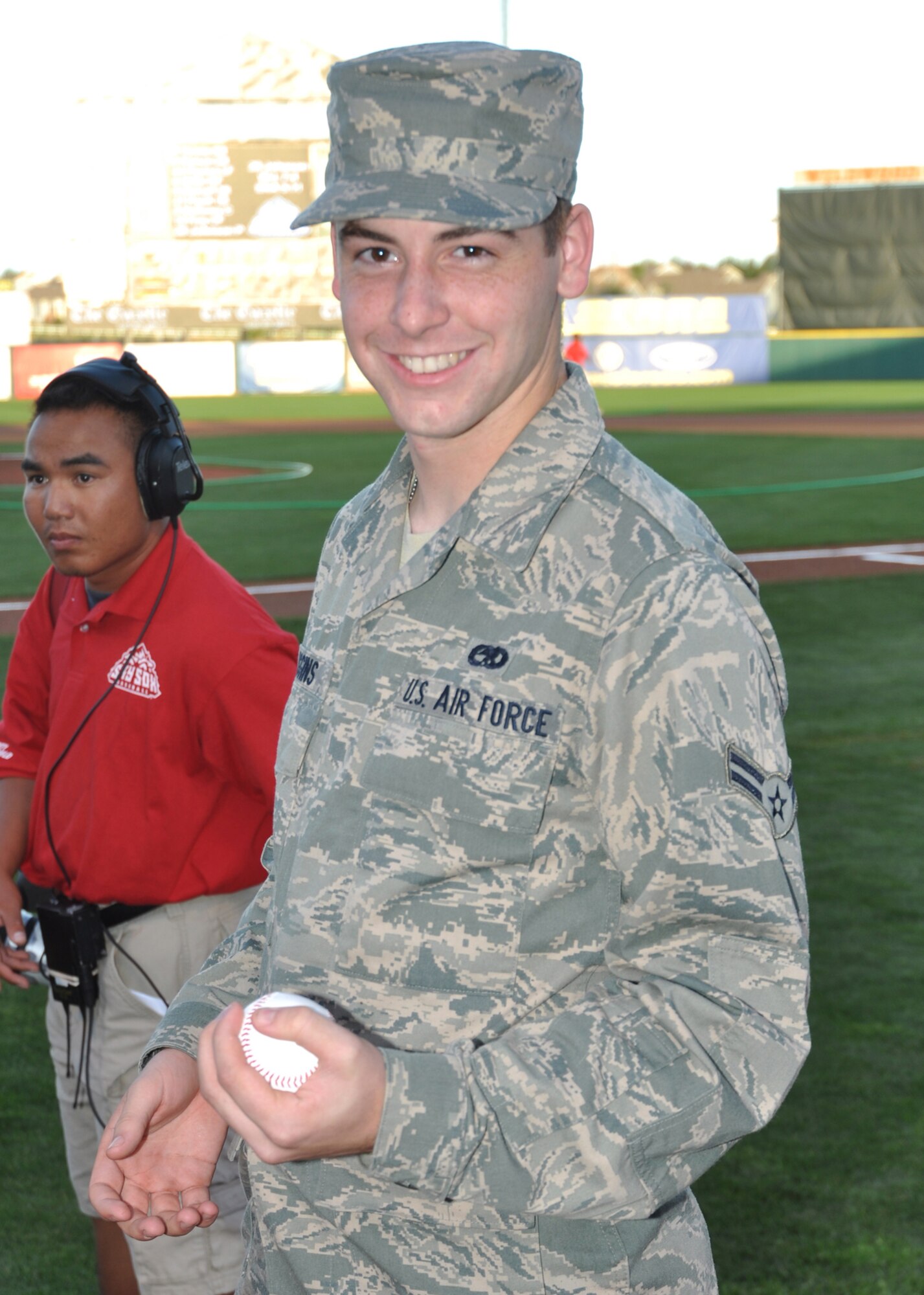 Airman 1st Class Tyler Higgins poses with his first-pitch baseball July 10 before throwing it out at Security Service Field in Colorado Springs, Colo. Airman Higgins, a C-130 avionics technician apprentice with the 52nd Airlift Squadron, was given the opportunity to throw out a first pitch at the Colorado Springs Sky Sox game because of his recent arrival to the squadron. The 52nd AS, an Active Duty C-130 organization, is associated with the Air Force Reserve's 302nd Airlift Wing. Both organizations are based at nearby Peterson Air Force Base. (U.S. Air Force photo/Staff Sgt. Stephen J. Collier)