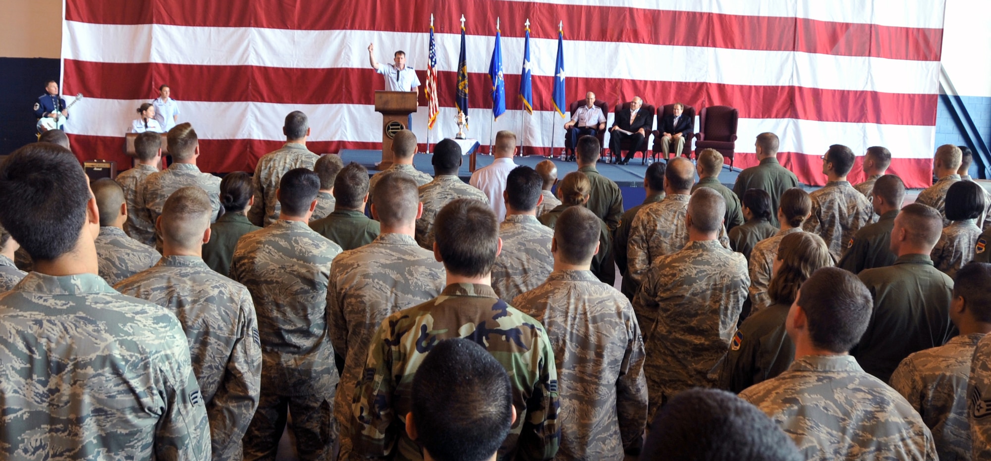 OFFUTT AIR FORCE BASE, Neb - 55th Wing Commander, Brig. Gen. John N.T. Shanahan, addresses more than 300 members of the 55th Wing July 7 at the Bennie Davis Maintenance Facility after accepting the Omaha Trophy for strategic aircraft operations on behalf of all Fightin' Fifty Fifth members. The Omaha Trophy is awarded annually to four military units demonstrating the highest performance standards in U.S. Strategic Command mission areas, according to the command. U.S. Air Force photo by Jeff W. Gates.
