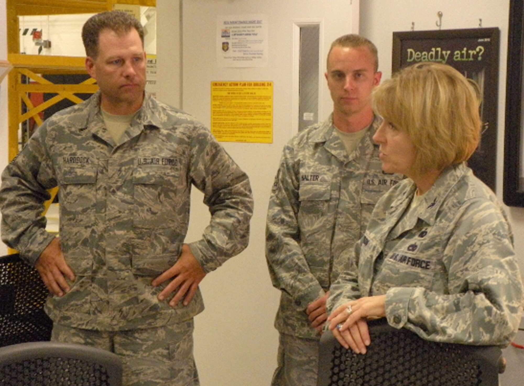 Col. Kathryn Johnson (right) talks with Air Force Reservists Master Sgt. Jeffrey Hardsock (left) and Airman 1st Class John Halter about the challenges they face working in the maintenance career field July 11 at Peterson Air Force Base, Colo. Colonel Johnson recently became the 22nd Air Force/A4 director of logistics and visited with the Airmen of the 302nd Maintenance Group to become more familiar with the organization's personnel, processes and capabilities. One of the focus items discussed during the visit was the importance of Airmen taking advantage of seasoning training opportunities to hone their maintenance skills. The 302nd MXG is a subordinate organization to the AF Reserve's 302nd Airlift Wing. Sergeant Hardsock is the 302nd Maintenance Squadron isochronal maintenance dock section chief, while Airman Halter is an aircraft inspector in the same section. (U.S. Air Force photo/Senior Airman April Migliore) 