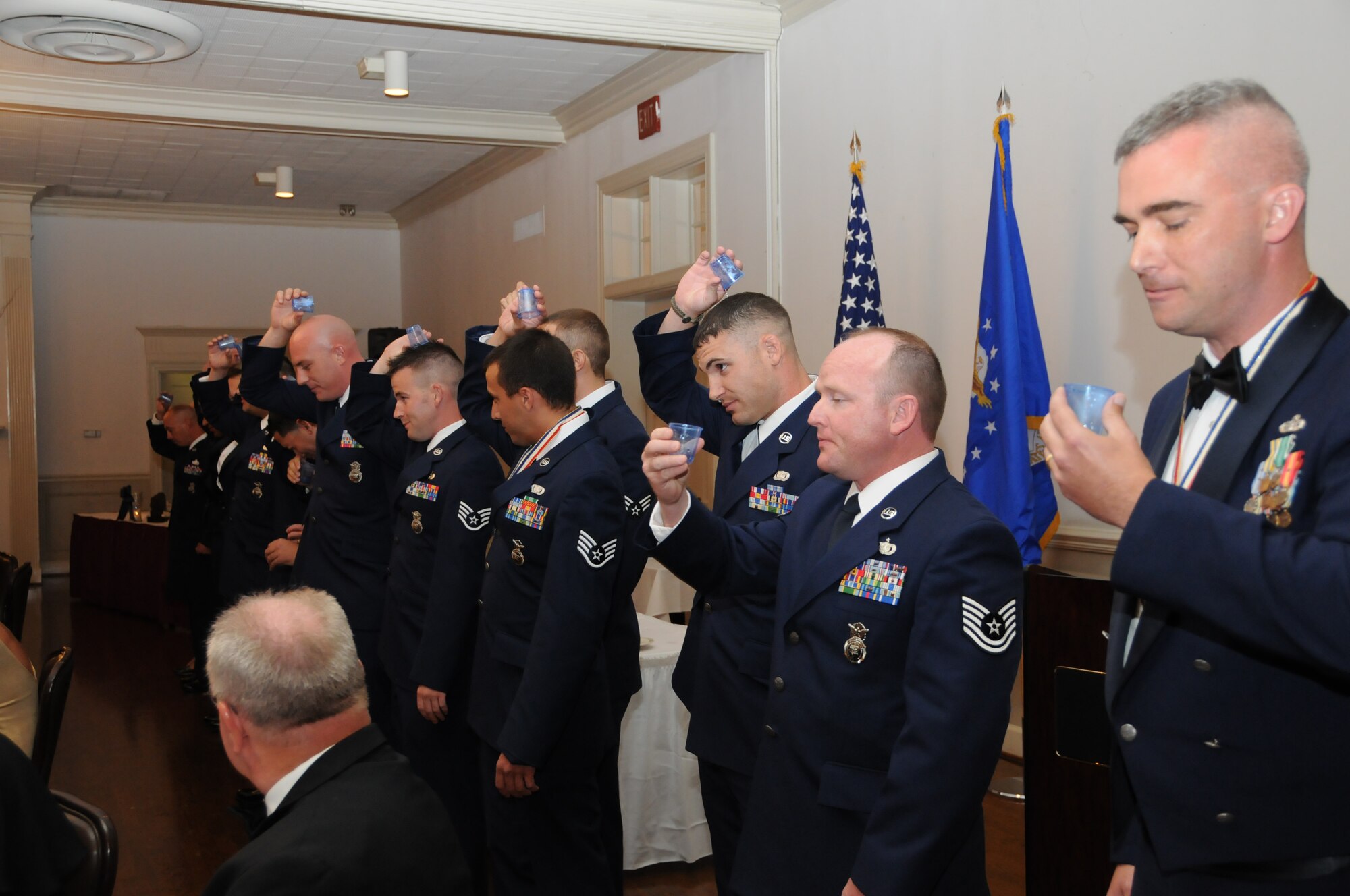 Reservists assigned to the 916th Security Forces Squadron pay for their antics during the wing's Dining Out held at the Goldsboro Country Club on July 10. The entire squadron's table was sent to the grog bowl as punishment for disobeying the rules of the evening. (USAF photo by TSgt. Scotty Sweatt, 916ARW/PA)