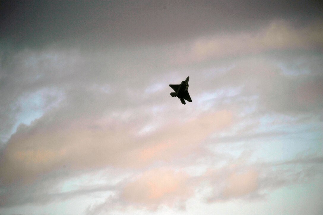 An F-22 Raptor is put through a demonstration display July 9, 2010, above the water surrounding the island of Oahu in Kapolei, Hawaii, as part of the dedication celebration of the F-22 becoming the new aircraft belonging to Joint Base Pearl Harbor-Hickam. (U.S. Air Force photo/Tech Sgt. Cohen A. Young)