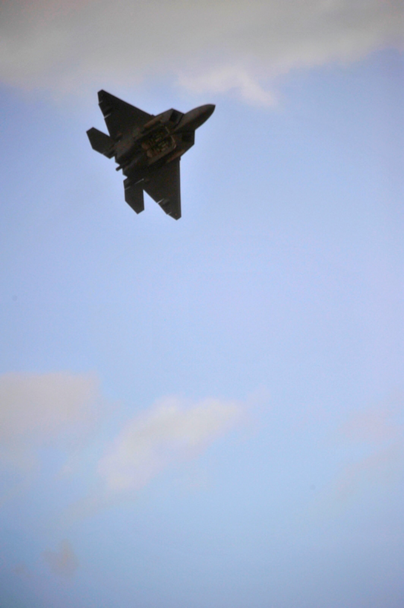 An F-22 Raptor is put through a demonstration display July 9, 2010, above the water surrounding the island of Oahu in Kapolei, Hawaii, as part of the dedication celebration of the F-22 becoming the new aircraft belonging to Joint Base Pearl Harbor-Hickam. (U.S. Air Force photo/Tech Sgt. Cohen A. Young)