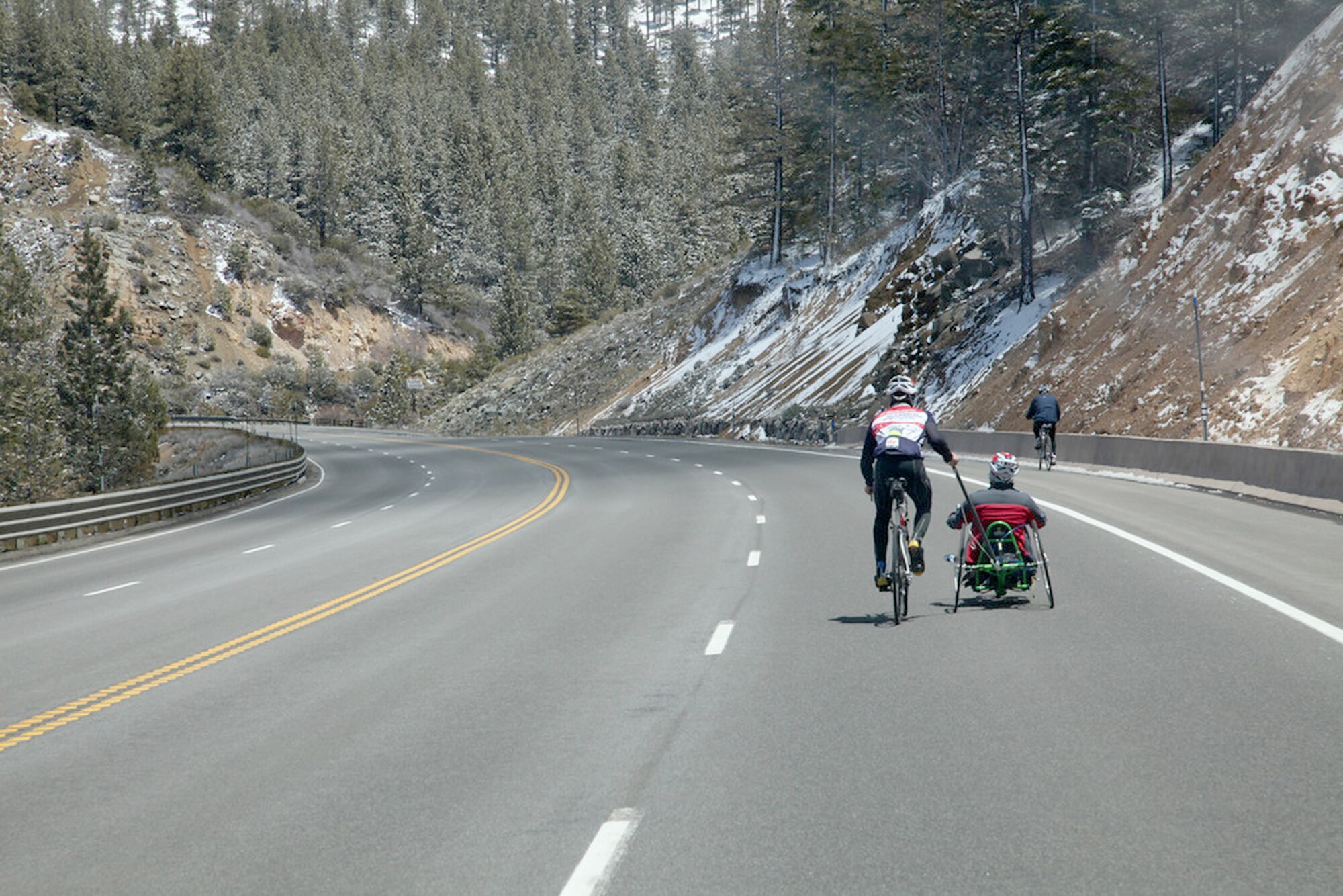 Staff Sgt. Marc Esposito assists a teammate going through the Sierra Nevadas. Sergeant Esposito is participating in Sea to Shining Sea, a 4,000-mile bike ride which started at the Golden Gate Bridge and will end July 24, 2010, in Virginia Beach, Va. The goal of the ride is to honor the courage of our service men and women, recognize the strength of the American spirit and challenge perceptions of how we view athletes. Sergeant Esposito is from the 21st Special Tactics Squadron at Pope Air Force Base, N.C. (Courtesy  photo/Austin Smithard)