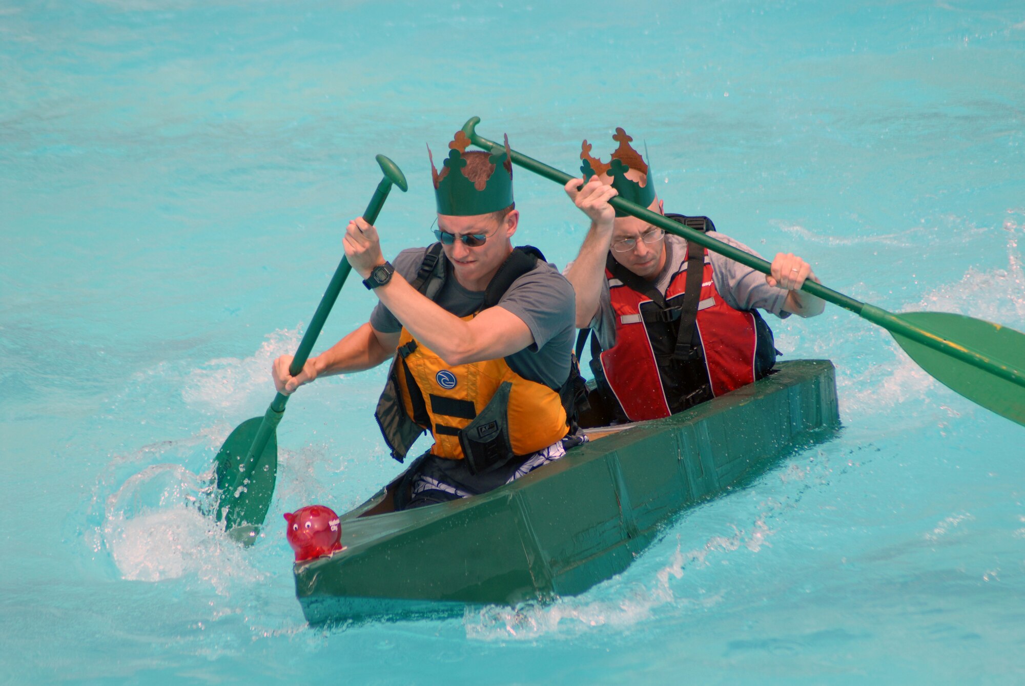 1st Lt. Matthew Miller (front) and Staff Sgt. Joseph D’Andria compete for the 43rd Comptroller Squadron during the 2010 Pope Regatta at the Pope Pool, July 8. For the competition, Airmen handcrafted boats using only a few pieces of cardboard, duct tape and ingenuity. (U.S. Air Force Photo/1st Lt. Cammie Quinn)