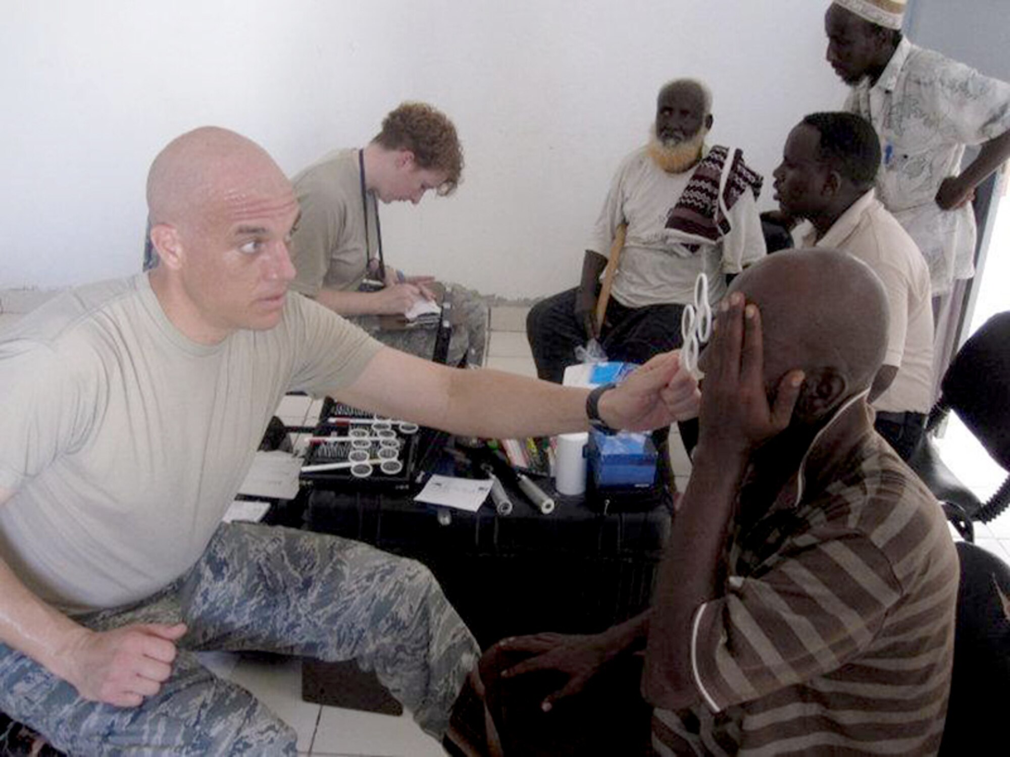 Maj. Justin Sandholm performs a refraction test for glasses June 3, 2010 during a Medical Civic Action Program in Djibouti, Africa. Major Sandholm was part of a 14-member medical team that treated approximately 900 patients over two days. Major Sandholm is an optometrist assigned to the 48th Aerospace Medicine Squadron. (U.S. Air Force photo/Tech. Sgt. Sarah Mayersky) 