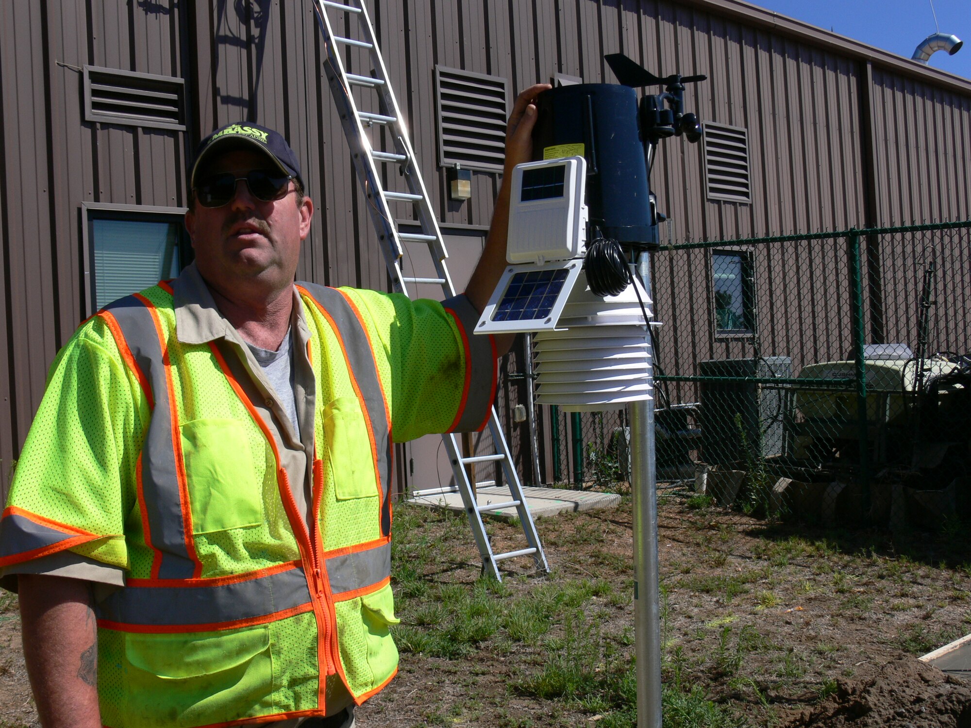 Rich Paquette, Embassy Lawn and Landscape head of irrigation on Peterson Air Force Base, explains the newly installed weather system tied directly to a central irrigation system. When there is even an eighth of an inch of rain, the weather system tells the irrigation system to shut down. The new system is expected to reduce water used for irrigation on Peterson Air Force Base by 50 percent. Mr. Paquette, who used to turn off 100 sprinklers manually, said that now when it rains late in the evening he can just sit back and enjoy it. (U.S. Air Force photo/Monica Mendoza)