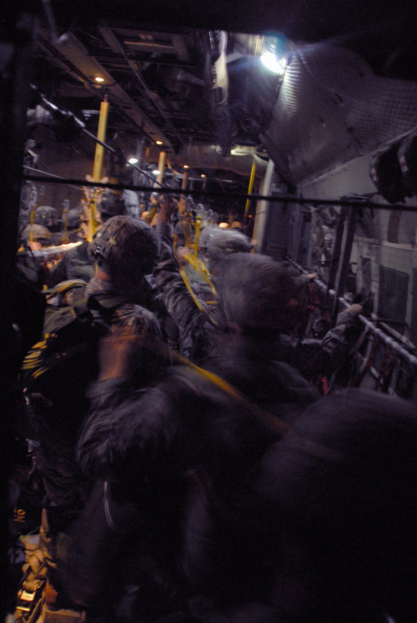 Army paratroopers from the 82nd Airborne Division, Fort Bragg, N.C., jump out of a C-130E Hercules June 22, 2010 during the first night of an 18-ship formation of C-130s and C-17 Globemaster IIIs that airdropped 1,117 paratroopers along with cargo. (U.S. Air Force photo/Capt. Joe Knable) 