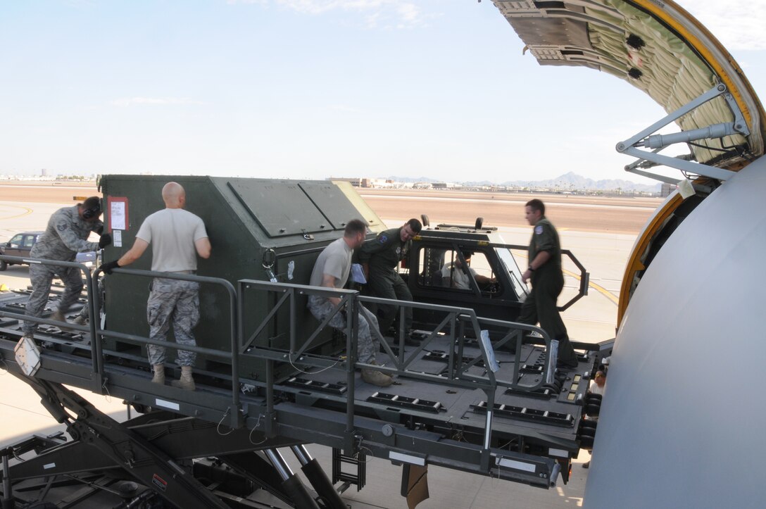 PHOENIX, AZ -- Members of the 161st Aerial Port Flight guide a K-Loader closer to a KC-135R at Phoenix Sky Harbor Air National Guard Base, July 11, 2010. Personnel conducted training during a real world mission. (U.S. Air Force photo by Master Sgt. Charles M. Wade) (Released)