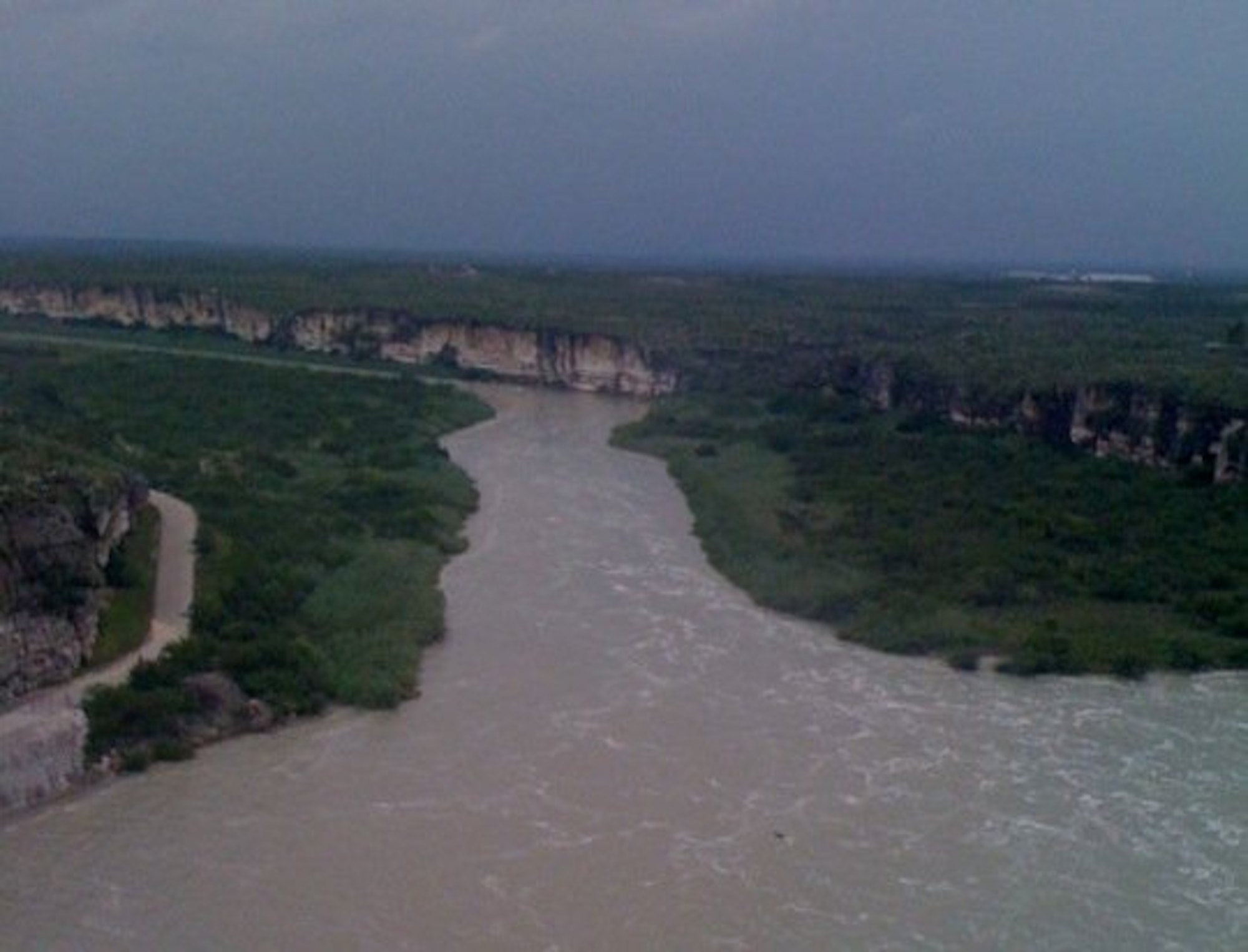 LAUGHLIN AIR FORCE BASE, Texas -- Water pours into the Rio Grande River as 1,000 cubic meters of water per second are released into the already swollen river. Laughlin's Top Three Association has organized a drive to assist those affected by the flooding in the Del Rio community. (U.S. Air Force photo by Joel Langton)