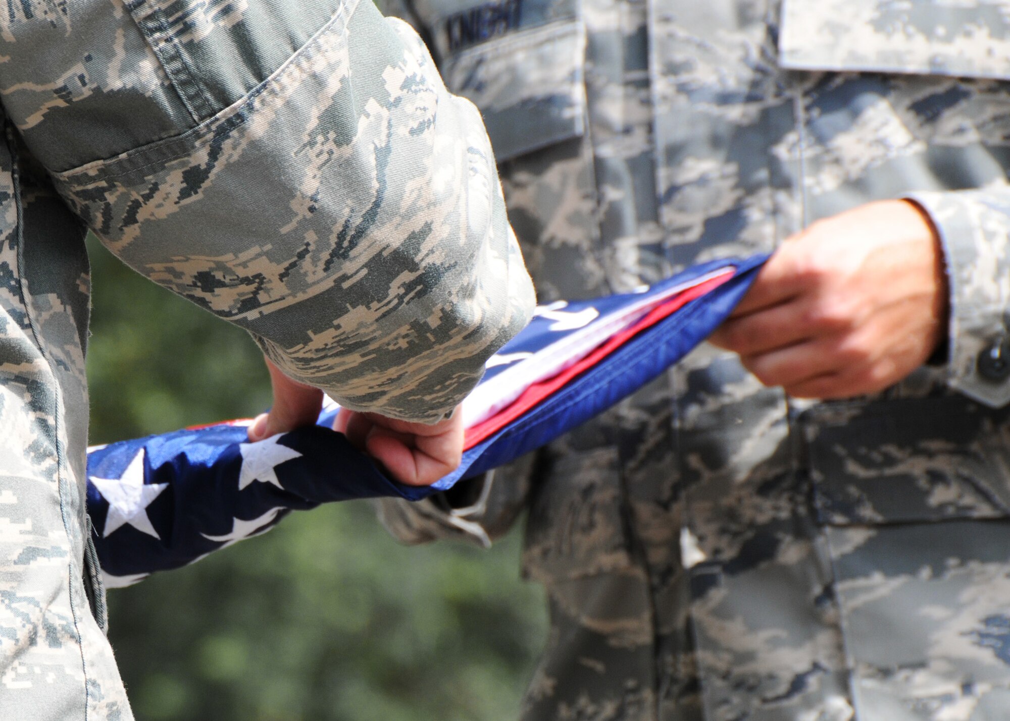Members of the 919th Security Forces Squadron, practice folding the flag prior to a flag-raising ceremony July 11 at Duke Field. (U.S. Air Force photo/Tech. Sgt. Samuel King Jr.)