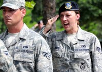Senior Airman Delania Moose, 919th Security Forces Squadron, gives the call to “order arms” during a flag-raising ceremony July 11 at Duke Field. (U.S. Air Force photo/Tech. Sgt. Samuel King Jr.)