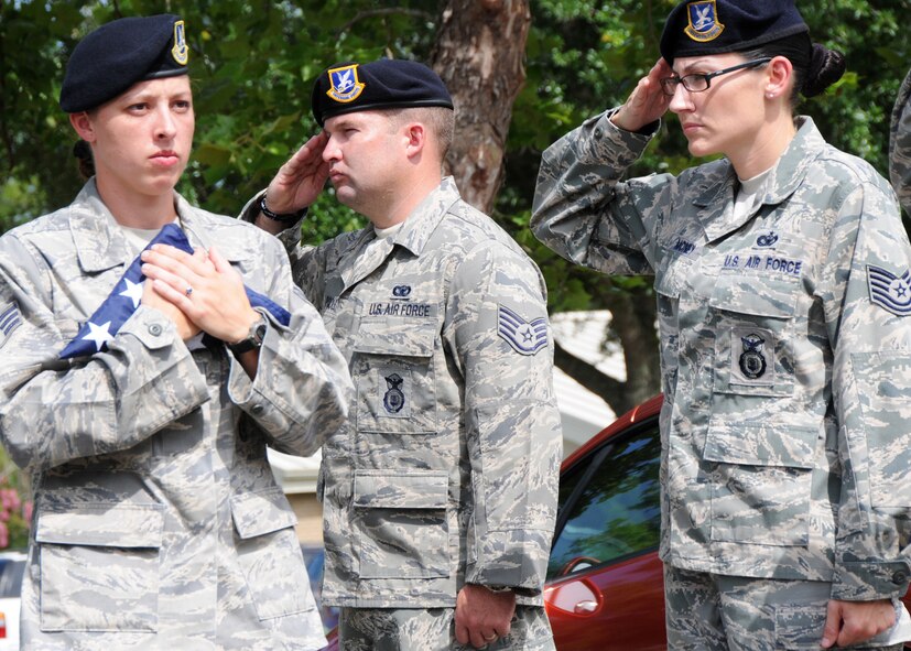 Senior Airman Delania Moose, 919th Security Forces Squadron, carries the flag for presentation during a flag-raising ceremony July 11 at Duke Field. (U.S. Air Force photo/Tech. Sgt. Samuel King Jr.)