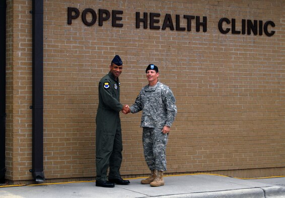 Col. James Johnson, 43rd Airlift Wing Commander and Army Col. Rolando Castro Jr., Acting Commander of the Womack Army Medical Center, unveil the sign for the Pope Health Clinic during the transition of authority ceremony July 1. The ceremony signified the transfer of authority over the clinic from the 43rd Medical Squadron to Womack. (U.S. Air Force photo/Senior Airman Kris Levasseur)
