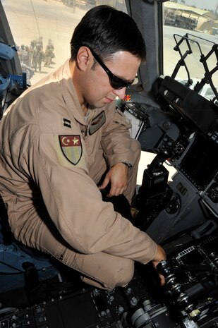Capt. Ryan Alvey, 817th Expeditionary Airlift Squadron, Aircraft Commander, goes through the pre-flight checklist on a C-17 Globemaster III July 10, 2010 at Sather Air Base, Iraq. Air Force assets are playing a vital role in the Iraq drawdown to 50,000 troops by August 31, 2010. (U.S. Air Force photo by Senior Airman Perry Aston) (Released)