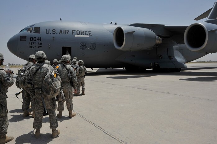 Members of Charlie Company, 67th Expeditionary Signal Battalion, out of Fort Gordon, Ga, board a C-17 Globemaster III from the 817th Expeditionary Airlift Squadron, Incirlik Air Base, Turkey, deployed from Charleston Air Force Base, S.C. July 10, 2010 at Sather AB, Iraq. Charlie Co. provided tactical communications within Iraq during their 12 month deployment. (U.S. Air Force photo by Senior Airman Perry Aston) (Released)