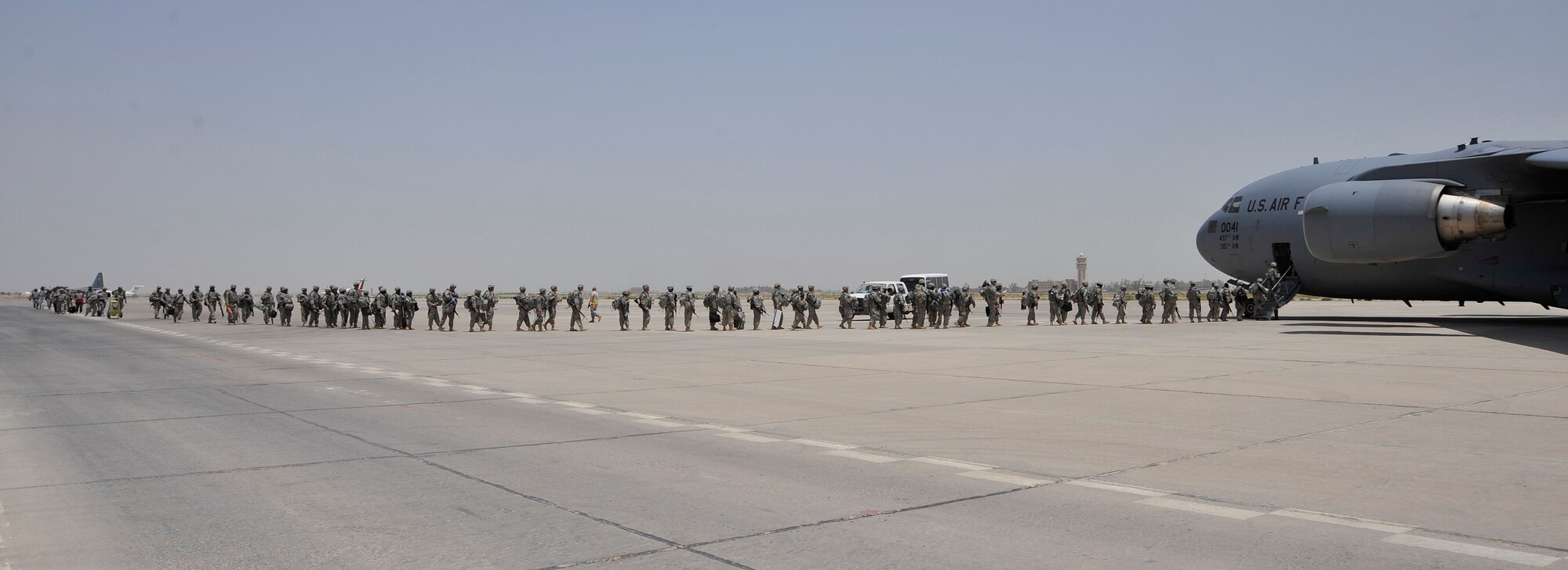 Members of Charlie Company, 67th Expeditionary Signal Battalion, out of Fort Gordon, Ga, board a C-17 Globemaster III from the 817th Expeditionary Airlift Squadron, Incirlik Air Base, Turkey, deployed from Charleston Air Force Base, S.C.  July 10, 2010, at Sather AB, Iraq. Charlie Co. is redeploying to their home unit as part of the drawdown to 50,000 troops in Iraq by August 31, 2010. (U.S. Air Force photo by Senior Airman Perry Aston) (Released)