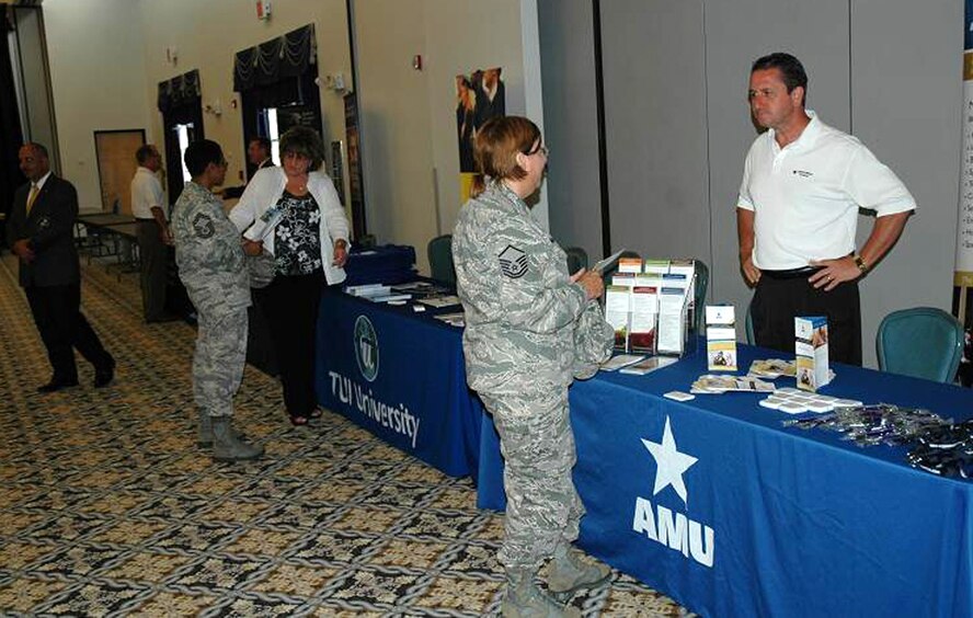 DOVER AIR FORCE BASE, Del.- Liberty Wing reservists discuss educational opportunities with military representatives from various colleges and universities at the education fair at the Landings Club here July 11. The fair gave reservists an opportunity to explore ways to take advantage of the new Post 9/11 GI Bill  (U.S. Air Force photo/Senior Airman Bhawan P. Singh)