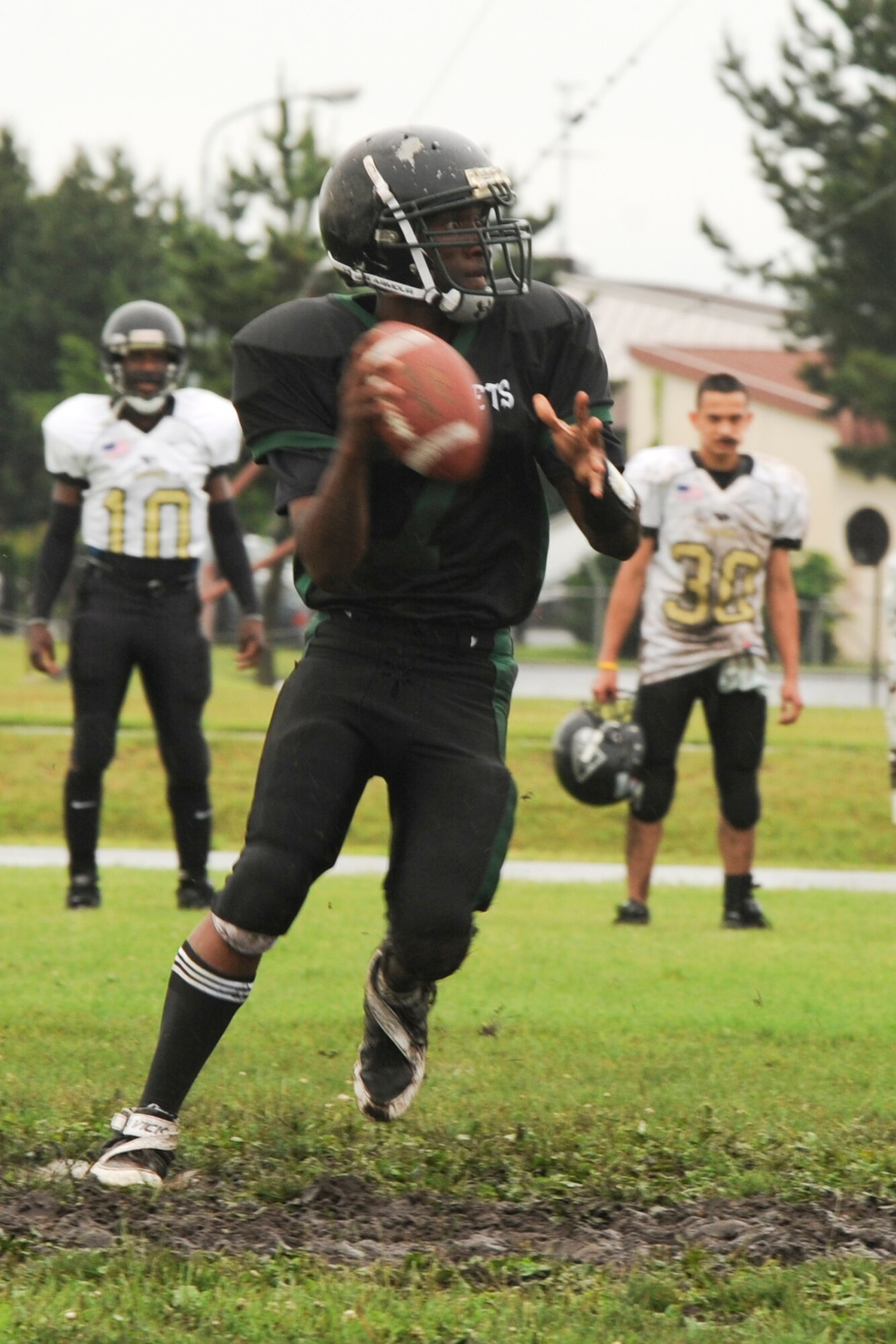 MISAWA AIR BASE, Japan – Jets’ quarterback Travis Haywood looks for an open receiver downfield during  the U.S. Forces Japan-American Football League North Division playoff opener at Hillside Stadium July 10. The Jets demolished the Yokosuka Seahawks 36 – 8, eliminating the Seahawks from contention. (U.S. Air Force photo/Tech. Sgt. Russell J. McBride)