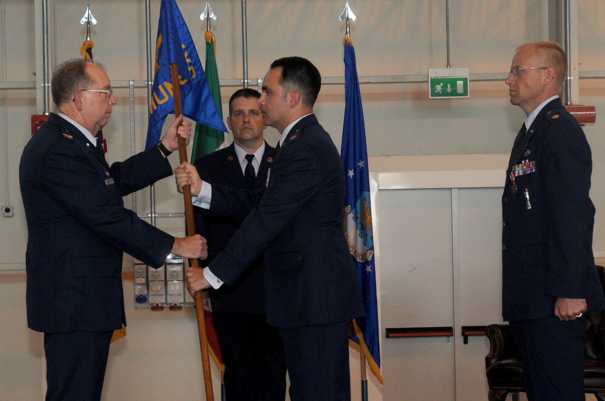 Maj. Jason F. Vattioni receives the flag of the 31st Munitions Squadron from Col. Dennis W. Shumaker, 31st Maintenance Group commander, during the squadron's change of command ceremony July 9 at Hangar 3. Major Vattioni is replacing Maj. Micheael W. Donahue II, Major Vattioni comes from the Naval War College in Newport, RI. (U.S. Air Force photo/Airman LaVel Sterling)