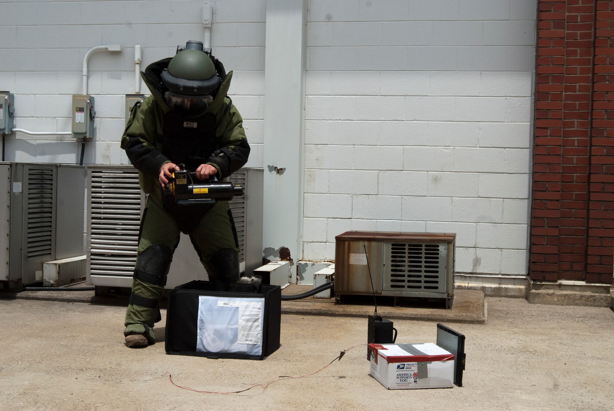 KUNSAN AIR BASE, Republic of Korea – Staff Sgt Wesley Kory, 8th Civil Engineering Squadron, explosive ordinance technician, wearing a protective suit prepares to x-ray a suspicious package with the RTR-4 digital x-ray system during exercise Beverly Bulldog 10-02 July 12. The RTR-4 system is designed to help law enforcement, military, customs and security personnel search for explosives, weapons, narcotics and other contraband.  The system can reveal the contents of parcels, baggage, boxes and crates among other things and is very helpful in the successful recovery of suspicious items left behind at a scene. (U.S. Air Force photo/Staff Sgt. Jonathan Pomeroy)