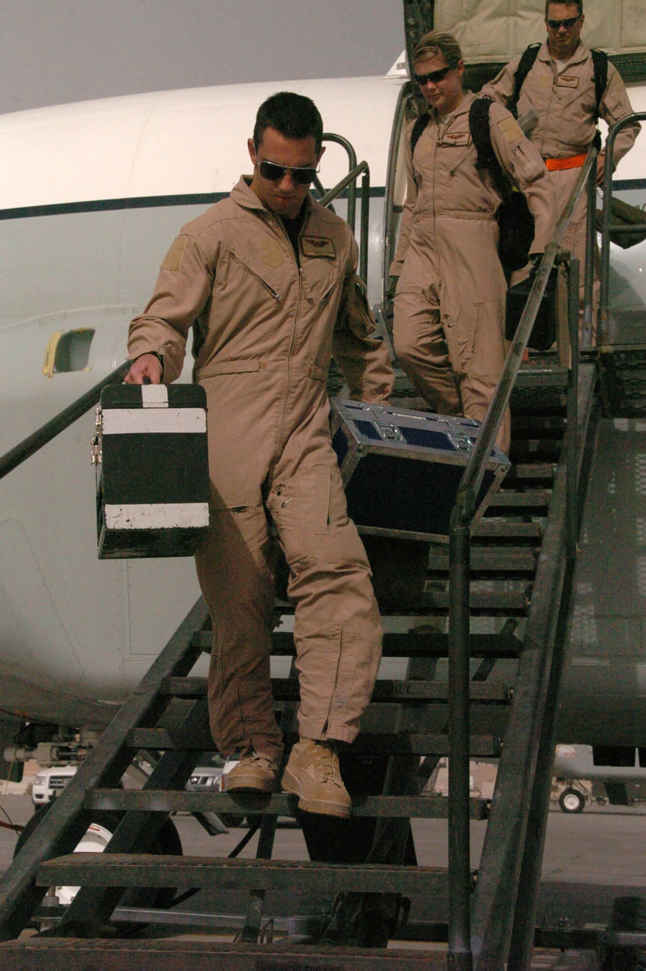 Senior Airman Kyle Levin, 763rd Expeditionary Reconnaissance Squadron Crytologic Operator, and Airman 1st Class Kristin Mauller and Tech. Sgt, Donald Stafford, 763rd ERS Airborne Systems Engineers, depart a RC-135V/W at an undisclosed location in Southwest Asia June 24 after completing the squadron’s 8,000th sortie in the U.S. Central Command area of responsibility. (U.S. Air Force photo/Tech. Sgt. Kimberly Spinner)