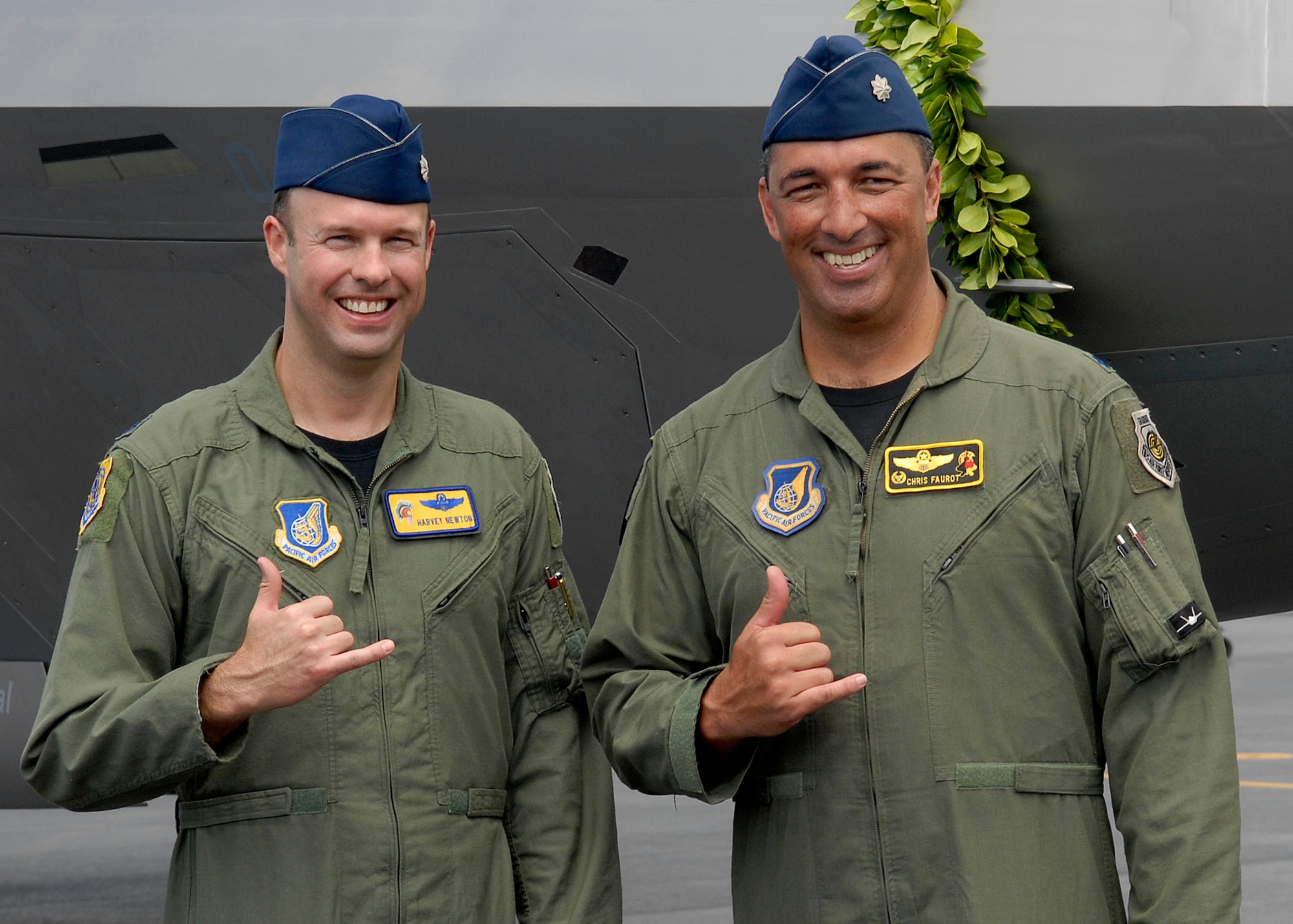 Lt. Col. Harvey "Banger" Newton, pilot 19th Fighter Squadron, and Lt. Col. Chris Faurot throwing up Hawaiian "shakas" at the F-22 Raptor Arrival Ceremony at Joint Base Pearl Harbor-Hickam, Hawaii, July 9, 2010. The arrival of the F-22 Raptor marks the beginning of a new associate unit between the Hawaii Air National Guard and the 15th Wing, active duty Air Force. The Raptor represents an exponential leap in warfighting capabilities for U.S. forces in the Pacific. (U.S. Air Force photo/Tech Sgt. Jerome S. Tayborn)