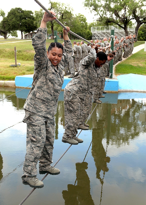 U.S. Air Force trainees cross a cold water pool during the basic training obstacle course on Lackland Air Force Base, Texas, June 30, 2010. The trainees are assigned to the 320th Training Squadron.