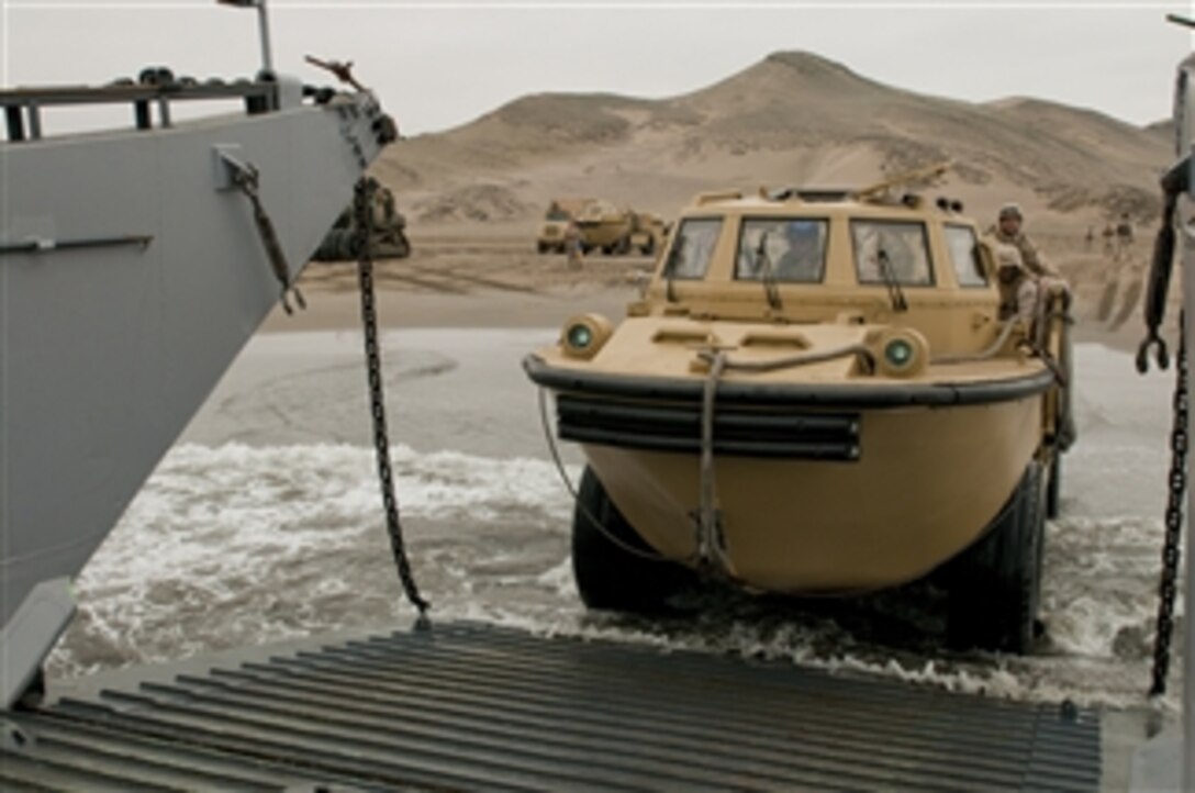 U.S. Navy Seaman Ashleigh Brown drives a lighter amphibious resupply cargo vehicle from Beach Master Unit 1 off of Salinas Beach, Peru, onto Landing Craft Unit 1617 during Amphibious-Southern Partnership Station 2010 on July 7, 2010.  