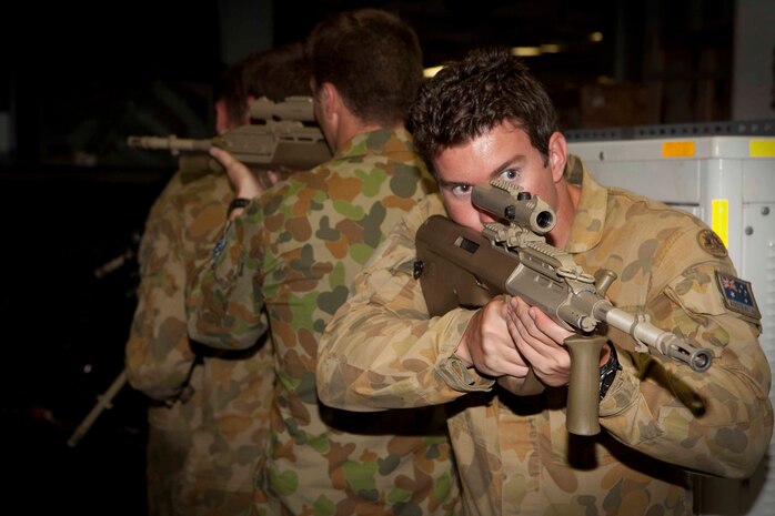 Pte. Matthew Harris, a signaler with Company B, 2nd Battalion, Royal Australian Regiment, Australian Army, aids in a hallway-clearing drill aboard the USS Bonhomme Richard (LHD-6) July 12. The drill was part of interoperability training between coalition forces assigned to the ground combat element of Special Purpose Marine Air-Ground Task Force 3 during the multi-lateral maritime Exercise Rim of the Pacific 2010.