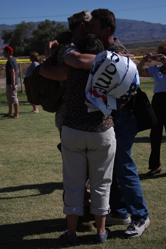 MARINE CORPS AIR GROUND COMBAT CENTER TWENTYNINE PALMS, Calif.--A Marine greets his family upon his return with the Battalion Landing Team 2nd Battalion 7th Marine Regiment from the 31st Marine Expeditionary Unit Tuesday at Del Valle softball field.