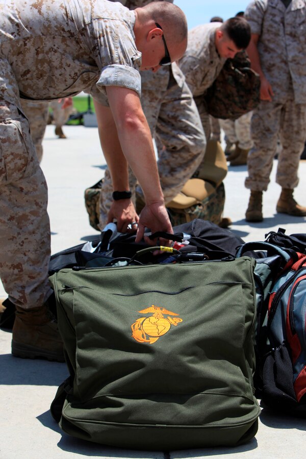 U.S. Marines and Sailors with Special-Purpose Marine Air-Ground Task Force Continuing Promise 2010 load gear before their flight at Marine Corps Air Station Cherry Point, N.C., July 13. The Marines and Sailors flew from Cherry Point to the USS Iwo Jima via CH-46E Sea Knight helicopters to deploy in support of Operation Continuing Promise 2010.