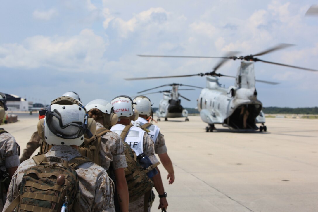 Marines with a Special-Purpose Marine Air-Ground Task Force march to CH-46E Sea Knight helicopters to be air lifted from Marine Corps Air Station Cherry Point, N.C. to the USS Iwo Jima, July 13. Marines and Sailors are deploying to various countries in support of Operation Continuing Promise 2010 to provide humanitarian assistance and disaster relief to Caribbean, Central and South America.