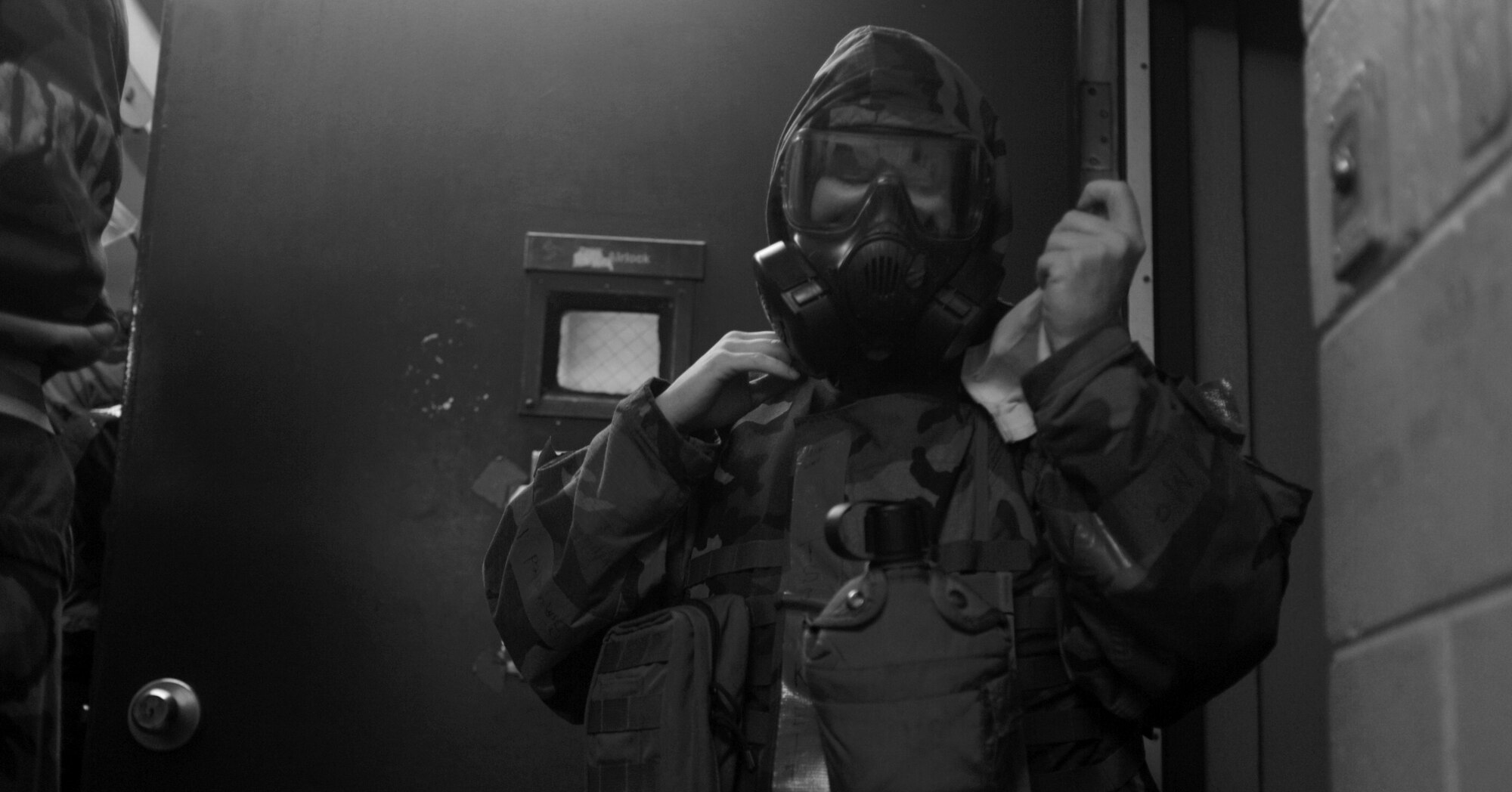 Tech. Sgt. Monika Keith, 51st Medical Group, adjusts her gas mask during the Operational Readiness Exercise Beverly Bulldog 10-02 at Osan Air Base, Rebuplic of Korea. (U.S. Air Force photo illustration/Senior Airman Evelyn Chavez)