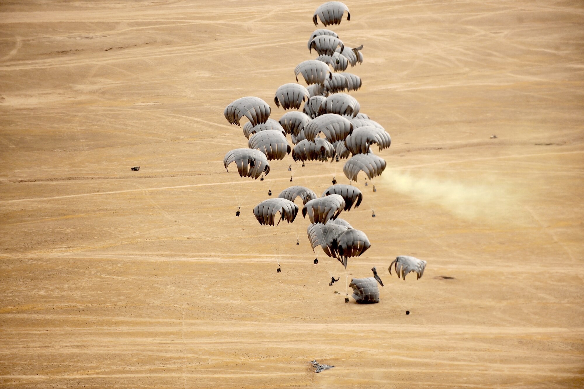 Container Delivery System bundles parachute to the ground from a C-17 Globemaster III transport jet over a drop zone May 9, 2010, in Afghanistan. (U.S. Air Force photo/Staff Sgt. Manuel J. Martinez)