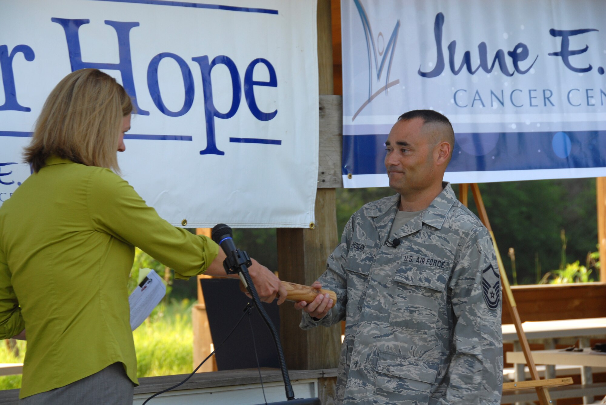 Master Sgt. Marty Hogan of the Air National Guard's 185th Air Refueling Wing accepts the baton as spokesperson for the 185th while at the Adams Homestead and Nature Preserve, McCook Lake, South Dakota on July 13, 2010. The 185th ARW was selected as the Honorary Race Ambassador Group for the June E. Nylen Cancer Center Race for Hope. 
(Photo by Air Force Photographer TSgt Brian Cox) (Released)