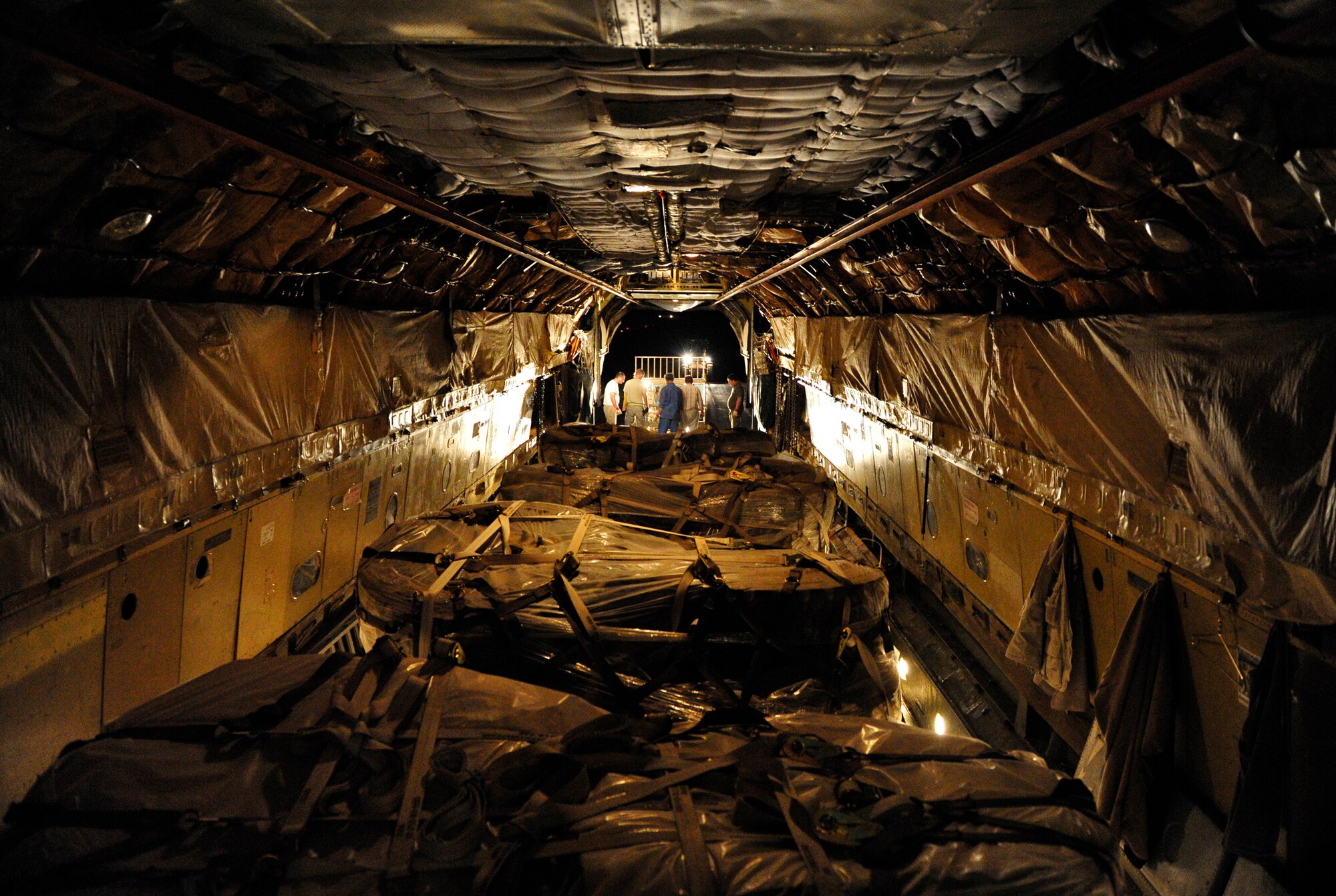 CAMP MARMAL, MAZAR-I-SHARIF, Afghanistan – Members of the 621st Contingency Response Wing from Joint-Base McGuire-Dix-Lakehurst, NJ, push a cargo pallet loaded with truck tires off of an Ilyushin IL-76 airlifter onto a waiting forklift at Camp Marmal, Afghanistan July 1. (U.S. Air Force photo/Tech. Sgt. Parker Gyokeres/released)