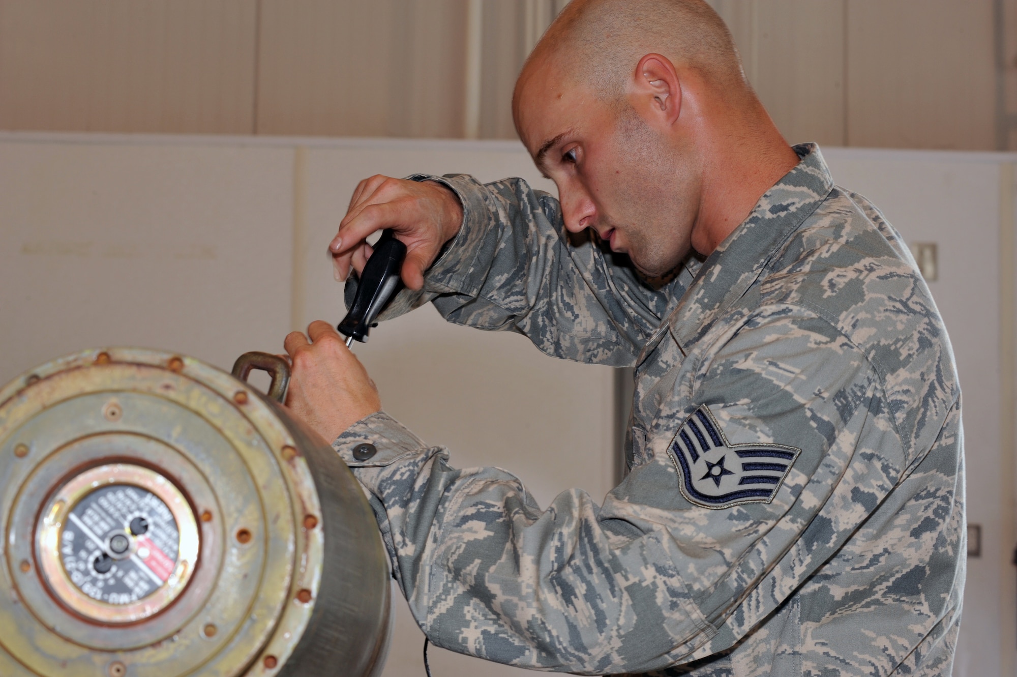 WHITEMAN AFB, Mo. - Staff Sgt. John Burkhart, 131st Bomb Wing crew chief, helps dismantle the MK-82 bombs following a bomb building practice session, Jul. 12. Sergeant Burkhart is a Missouri National Guardsman currently assigned to the 509th Munitions Squadron as a part of Total Force Integration. 