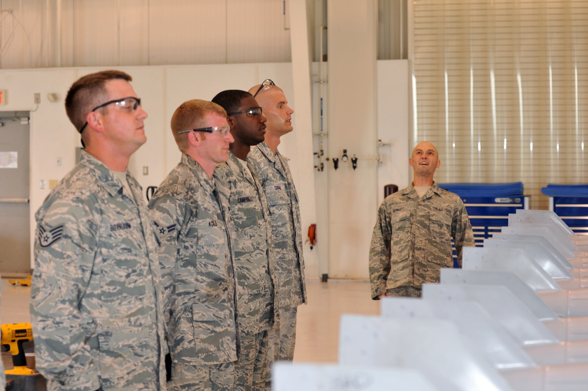 WHITEMAN AFB, Mo. - Staff Sgt. John Burkhart, 131st Bomb Wing crew chief, leads the 509th Munitions Squadron team in a rally-call after safely building the 500-pound MK-82 bombs, Jul. 12. Sergeant Burkhart is a Missouri National Guardsman currently assigned to the 509th MUNS as a part of Total Force Integration. 