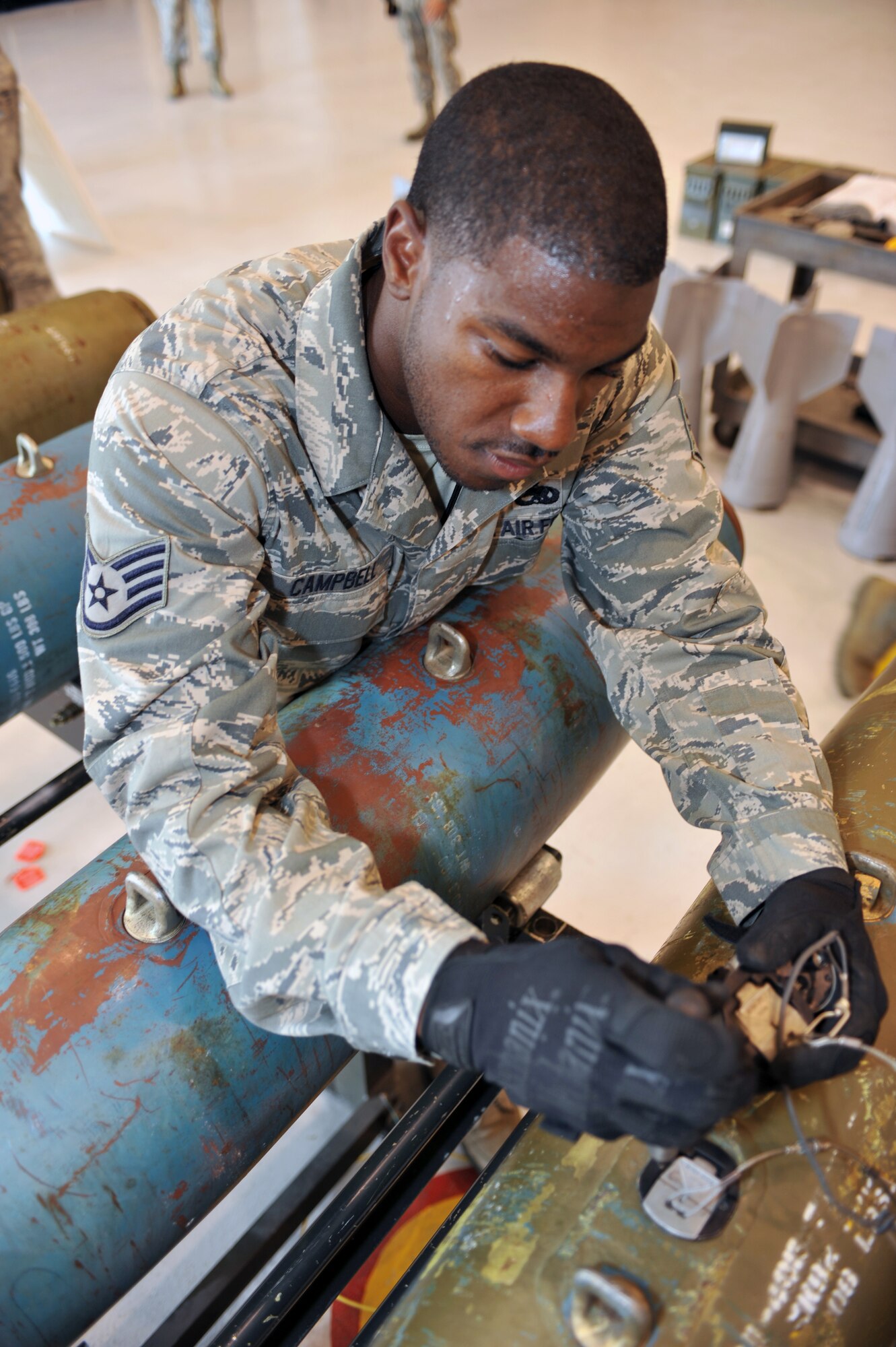 WHITEMAN AFB, Mo. - Staff Sgt. Tyler Campbell, 509th Munitions Squadron, installs an arming device into a 500-pound MK-82 bomb during a practice session for the Air Force Global Strike Command Challenge, Jul. 12. Sergeant Campbell was assigned to install the arming devices on each of the 12 bombs during the practice session. 