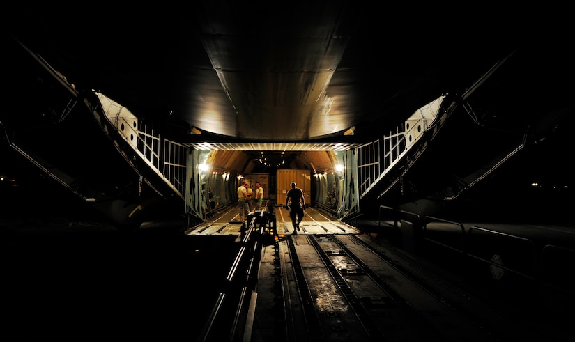 CAMP MARMAL, MAZAR-I-SHARIF, Afghanistan – A mobility Airman assigned to the 621st Contingency Response Wing from Joint-Base McGuire-Dix-Lakehurst, NJ, steps off of a C-5B Galaxy onto a Tunner 60K cargo loader at Camp Marmal, Afghanistan July 1. The team is deployed to Afghanistan to provide contingency aerial port capability for the deployment of an Army aviation brigade. (U.S. Air Force photo/Tech. Sgt. Parker Gyokeres/released)