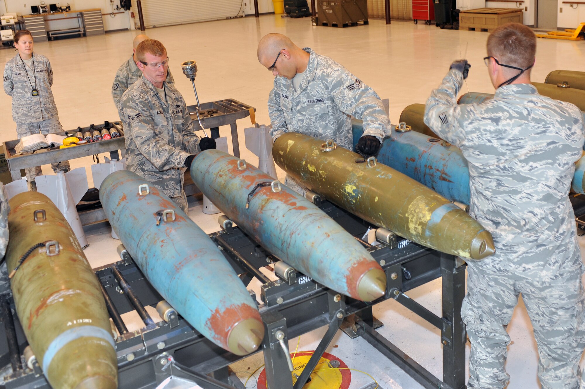 WHITEMAN AFB, Mo. - Airmen from the 509th Munitions Squadron work together to prepare 12 MK-82 bombs during a practice session for the Air Force Global Strike Command Challenge, Jul. 12. The seven-Airmen 509th MUNS team safely prepared all the 500-pound bombs in a short ammount of time.