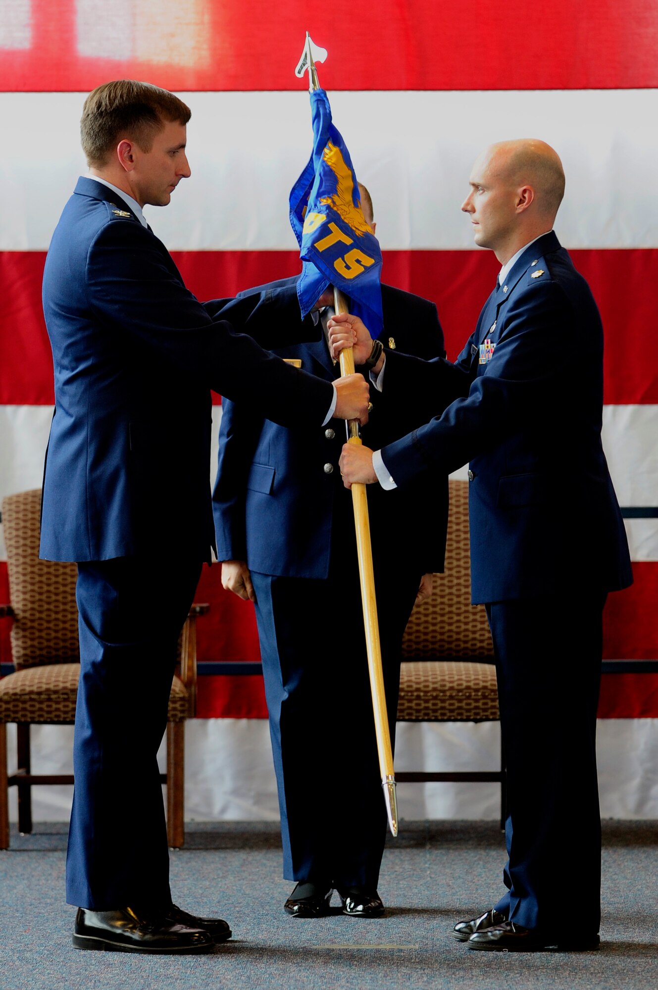 ELLSWORTH AIR FORCE BASE S.D. – Col. Jeffrey Taliaferro, 28th Bomb Wing commander, hands the 28th Comptroller Squadron guidon to Maj. Erik Dunn, 28 CPTS commander, July 12. (U.S. Air Force photo/Staff Sgt. Marc I. Lane)