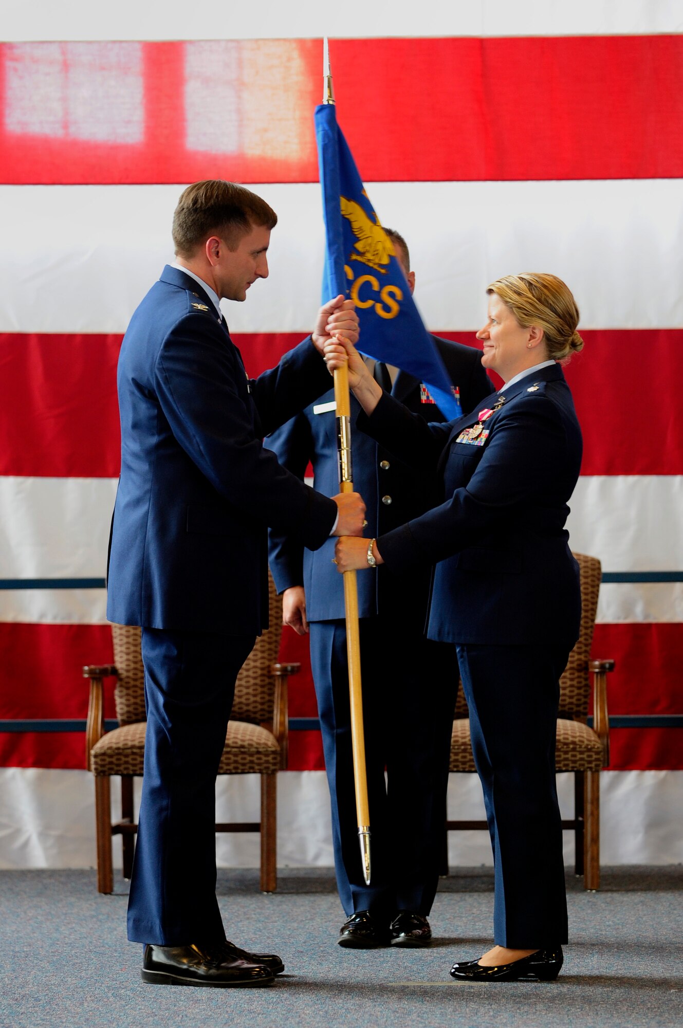 ELLSWORTH AIR FORCE BASE S.D. – Col. Jeffrey Taliaferro, 28th Bomb Wing commander, receives the 28th Comptroller and Contracting Squadron guidon from Lt. Col. Christine Wasdin, 28 CCS commander, July 12.  The 28 CCS was deactivated and divided into the 28th Comptroller Squadron and the 28th Contracting Squadron. (U.S. Air Force photo/Staff Sgt. Marc I. Lane)