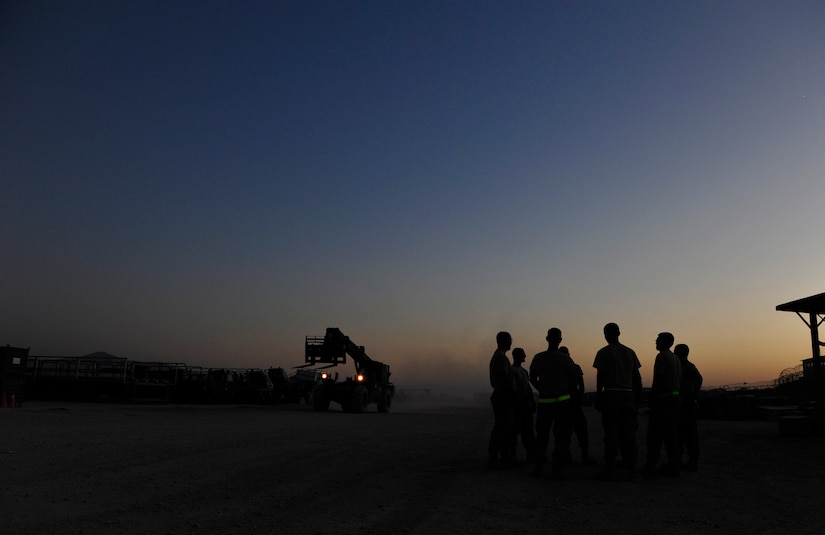 CAMP MARMAL, MAZAR-I-SHARIF, Afghanistan – A group of aerial porters assigned to the 621st Contingency Response Wing, based at Joint-Base McGuire-Dix-Lakehurst, NJ, wait at sunset for an arriving C-5B Galaxy inside the contingency cargo staging yard at Camp Marmal, Afghanistan July 1.  (U.S. Air Force photo/Tech. Sgt. Parker Gyokeres/released)